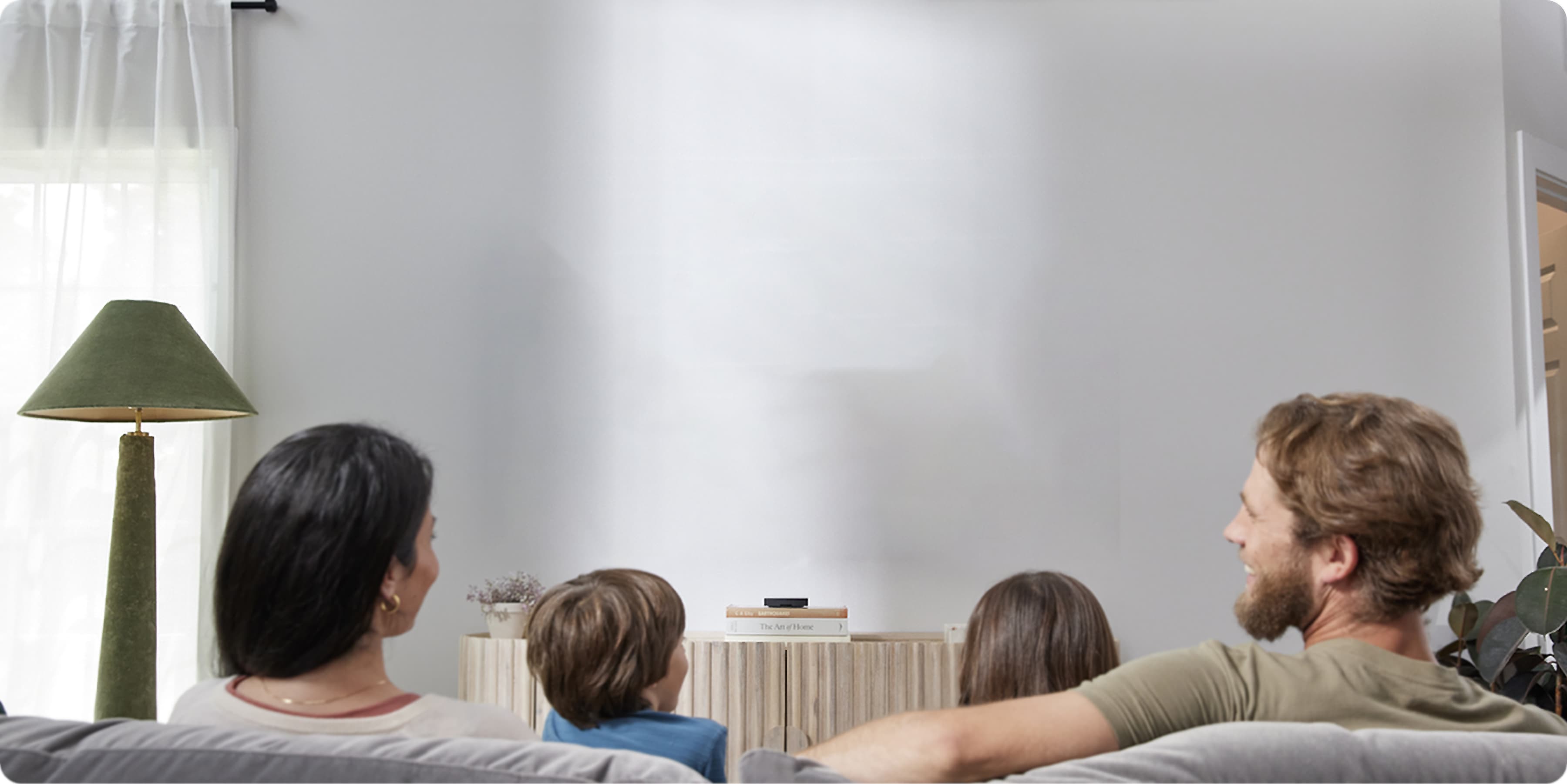 A picture of a family enjoying a Xumo Stream Box showing Squidgames from Netflix.